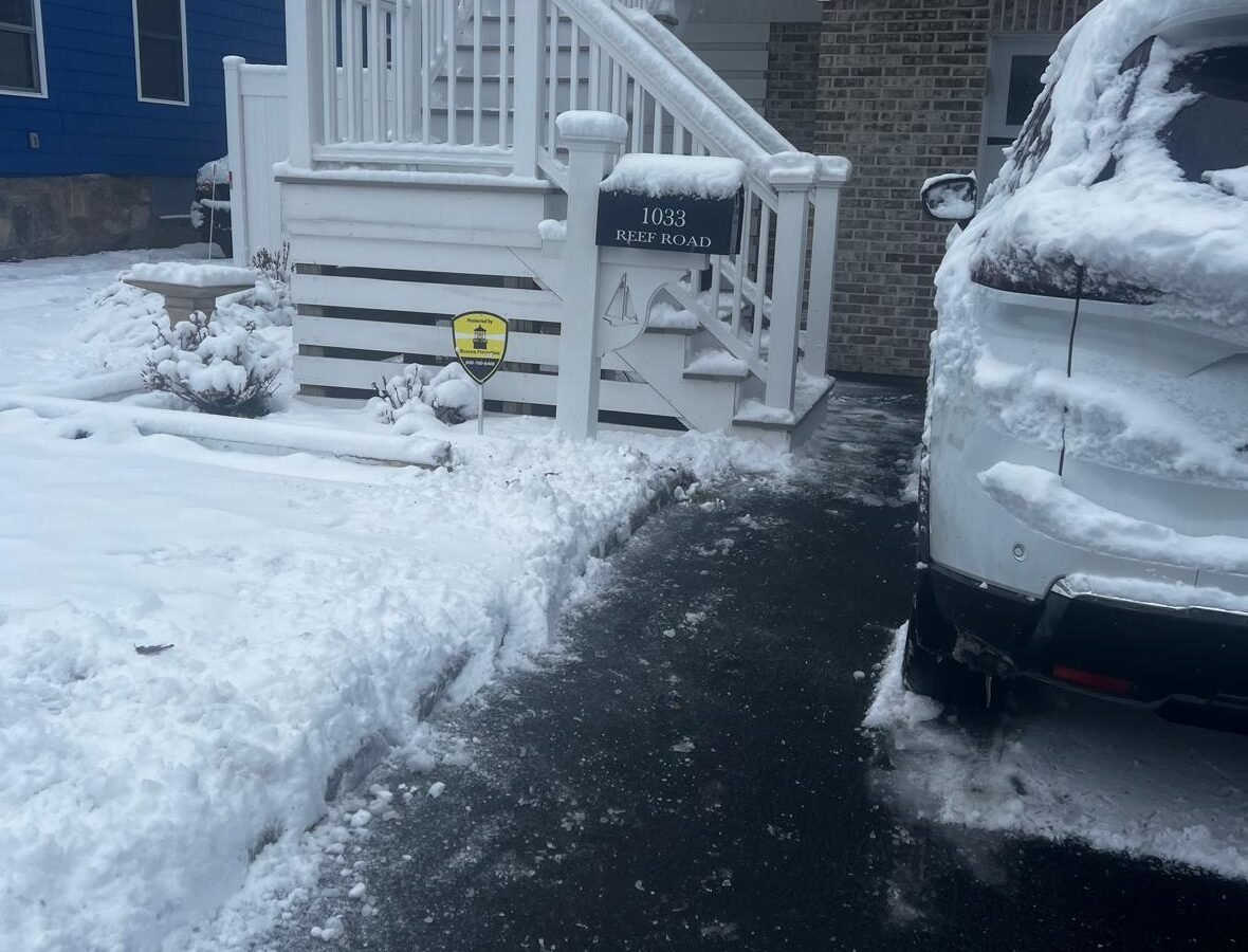 Snow plowing service clearing residential driveway for safe winter access in Connecticut.