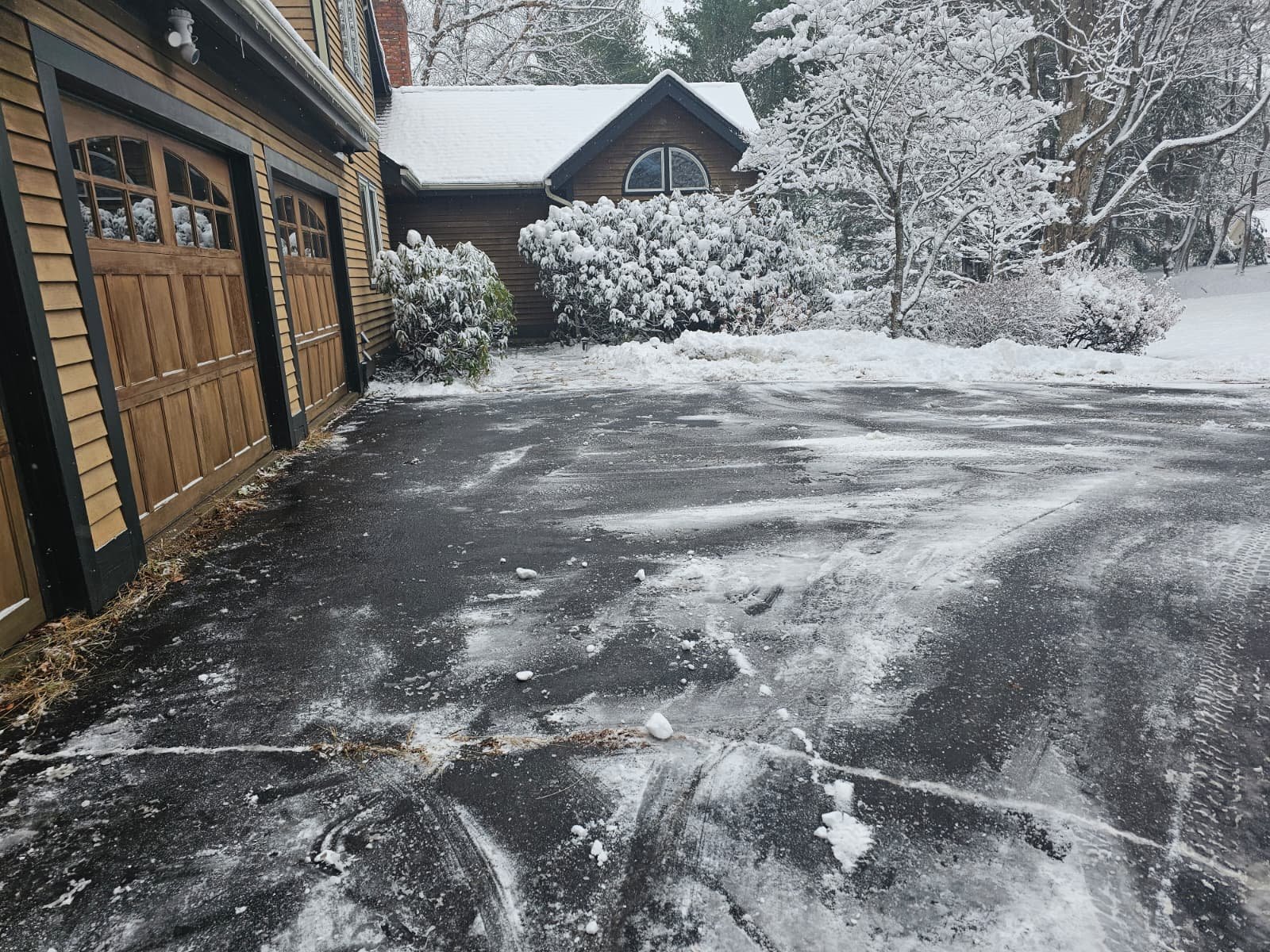 Snow plowing service clearing residential driveway for safe winter access in Connecticut.