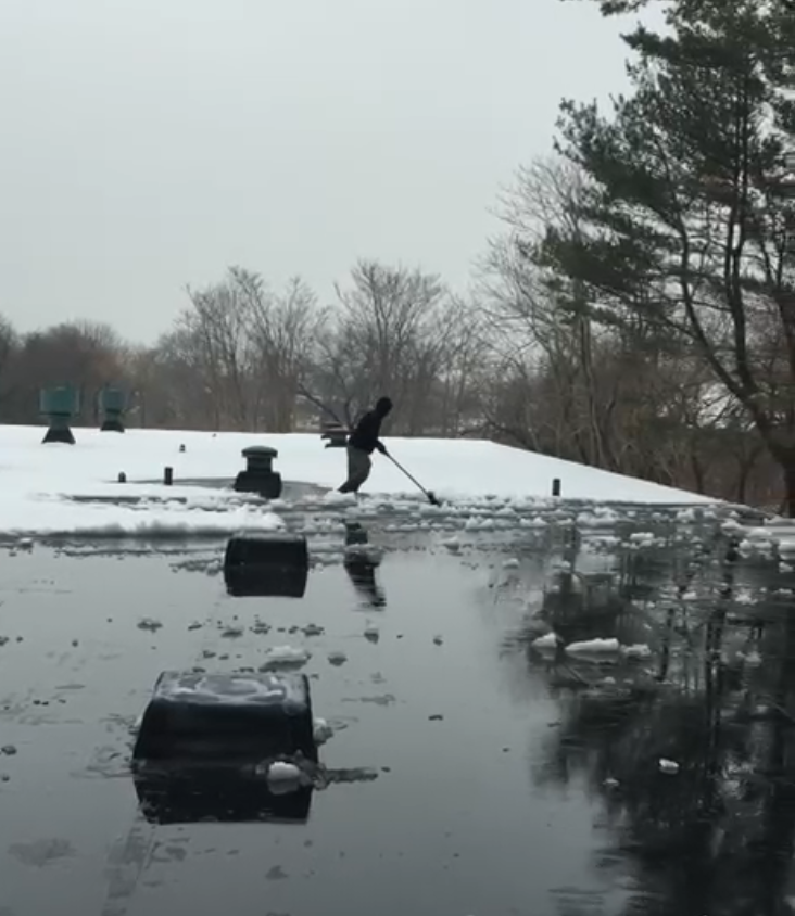 Snow plowing truck removing snow in Connecticut by M&G Landscaping & Lawn Care LLC during winter storm conditions.