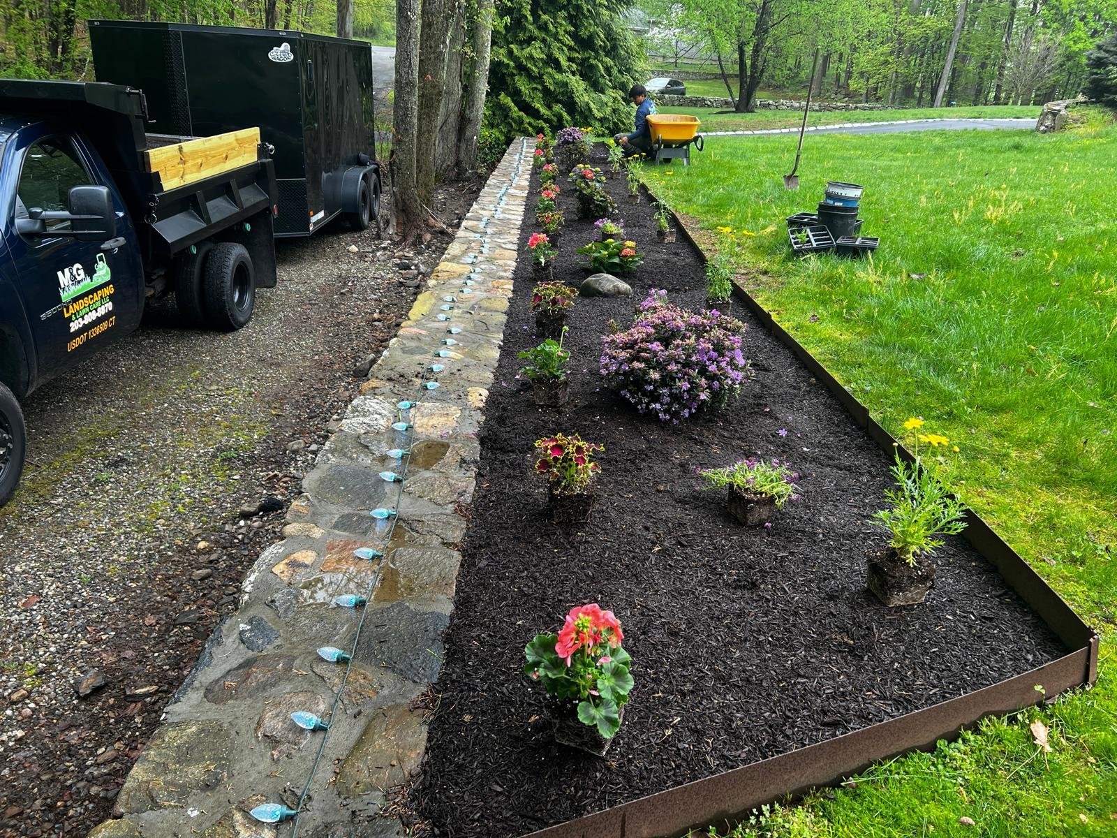 Mulching installation service in Connecticut by M&G Landscaping & Lawn Care LLC, improving soil health and landscape appearance.