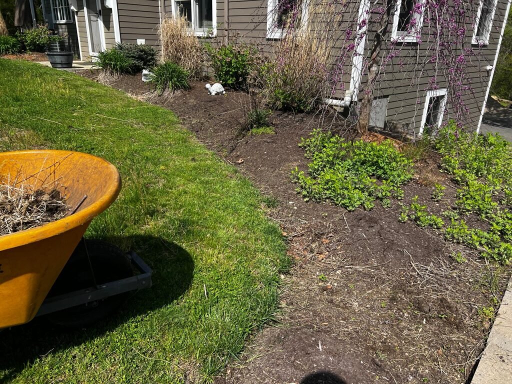 Mulching installation service in Connecticut by M&G Landscaping & Lawn Care LLC, improving soil health and landscape appearance.