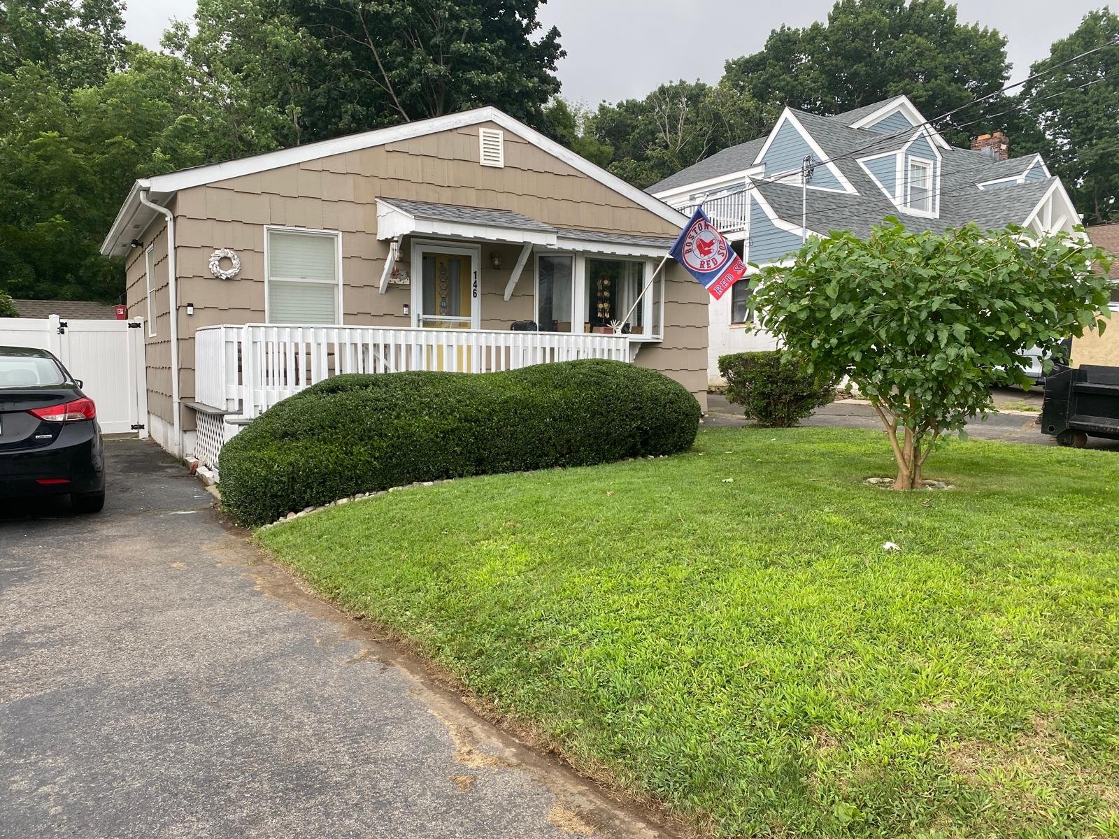 Bush trimming service at a residential property in Connecticut by M&G Landscaping & Lawn Care LLC, improving curb appeal and plant health.