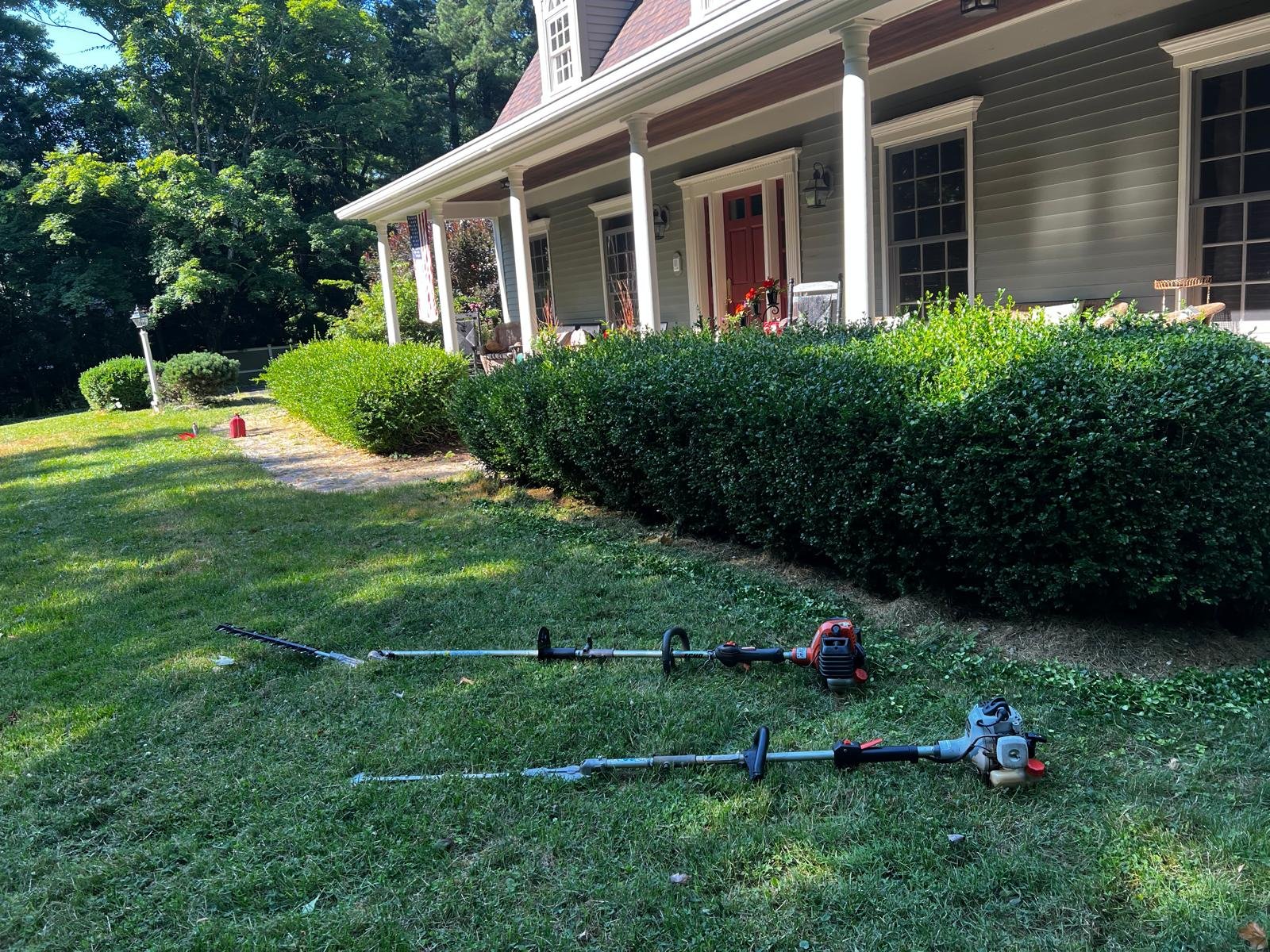Hedge trimming service improving curb appeal and maintaining healthy shrubs for residential properties in Connecticut.