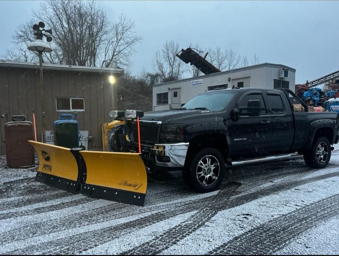 Snow plowing service clearing residential driveway for safe winter access in Connecticut.